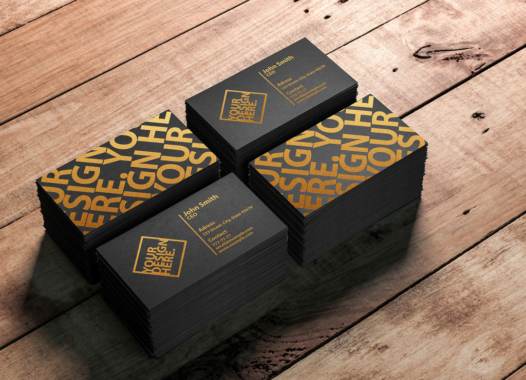 4 Stacks of Business Cards on a Wooden Table Mockup (PSD Format)