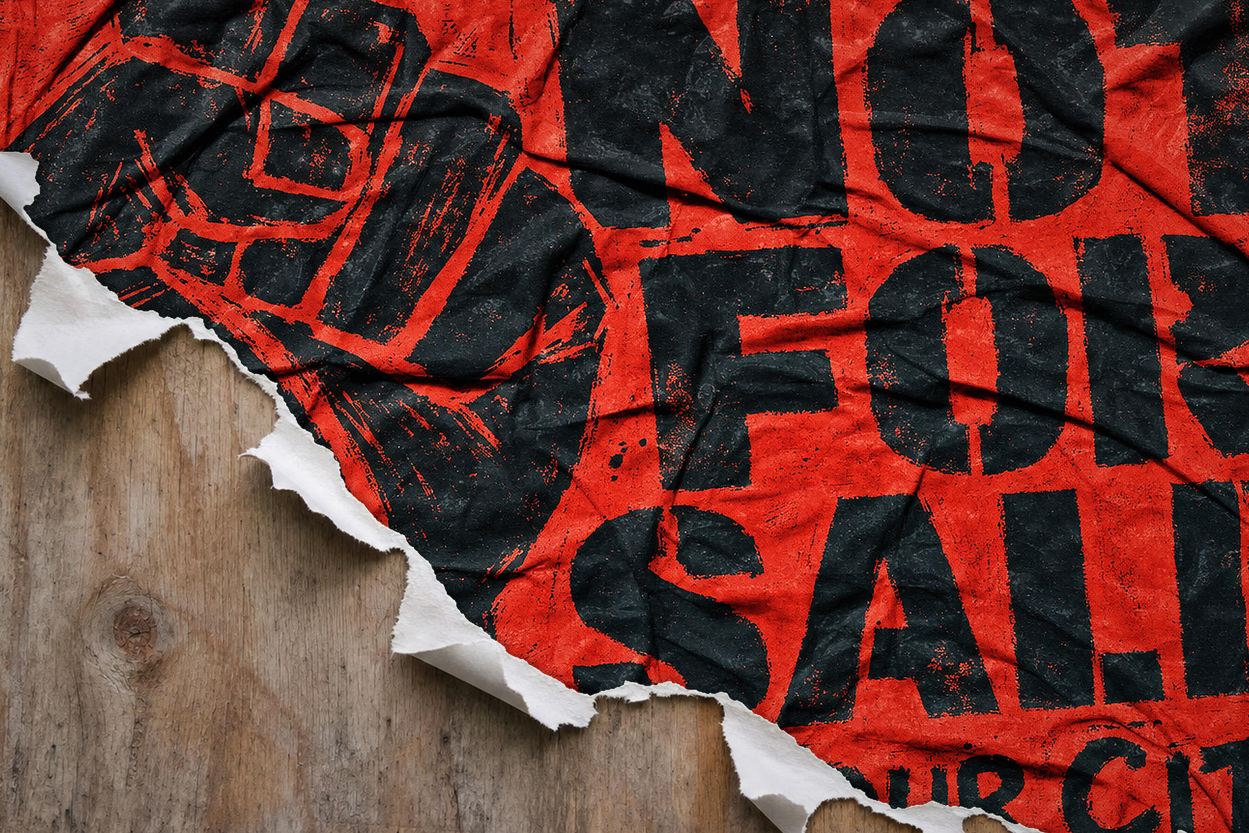 Torn red grunge poster with oversized black stencil lettering and a grenade illustration on wood