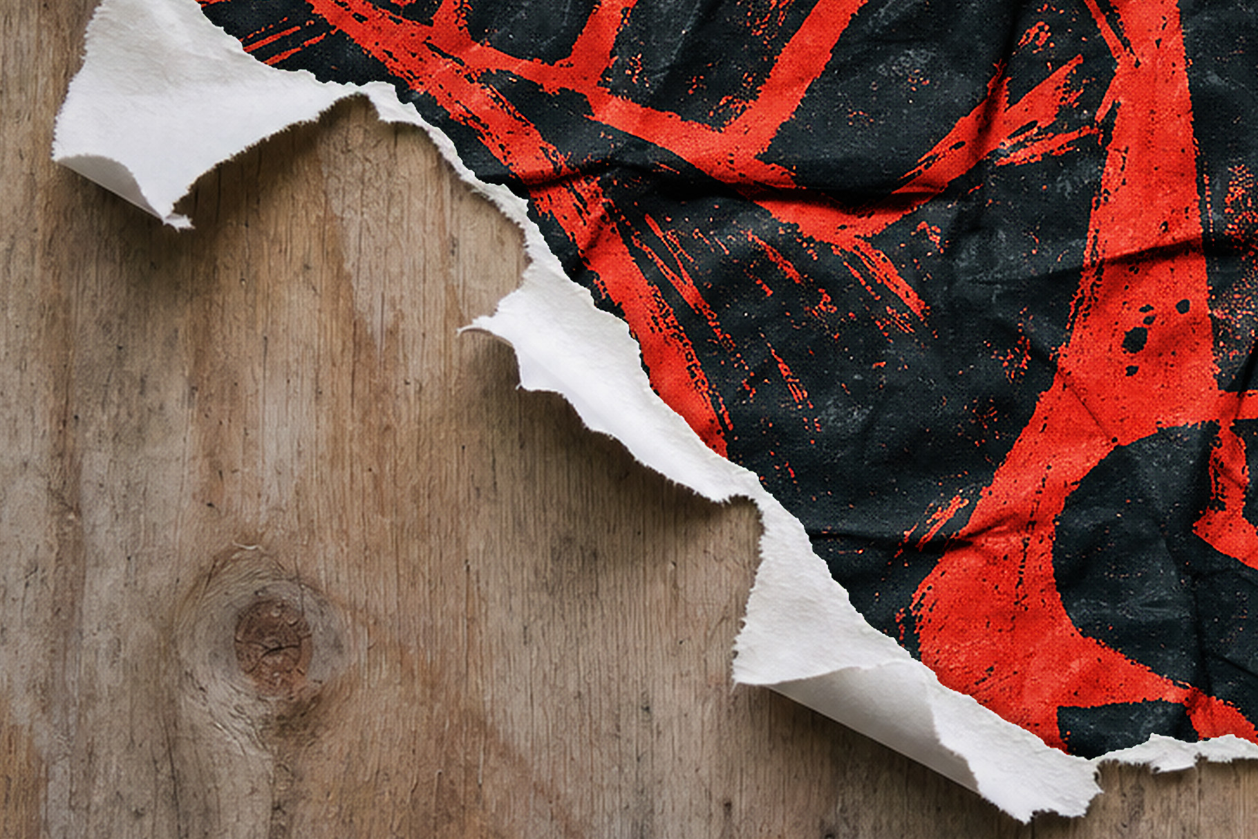 Red and black grunge poster with a diagonal torn white edge over a wood-grain background